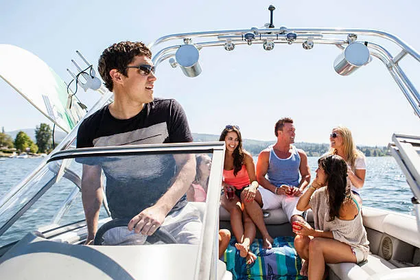 guys and girls relaxing on boat on a sunny day