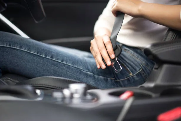 Person putting on seatbelt